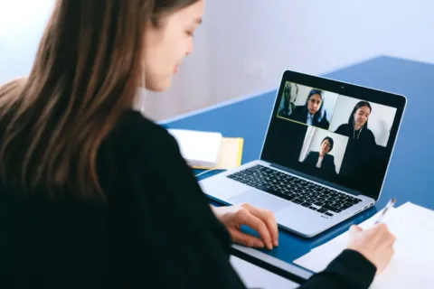 Webcam eksternal terpasang di atas monitor komputer untuk panggilan video kerja